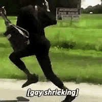 a man is running down a road while holding a guitar and a bag .