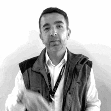 a man wearing a vest and a lanyard with the word panasonic on it