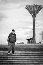 a man is standing on a set of stairs with a skateboard in his hand .