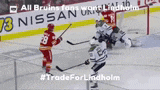 a hockey game is being played in front of a nissan sign