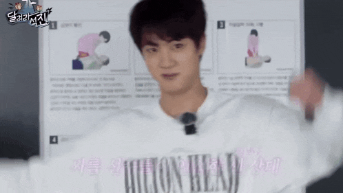 a young man wearing a white shirt that says ' cotton wear ' on it