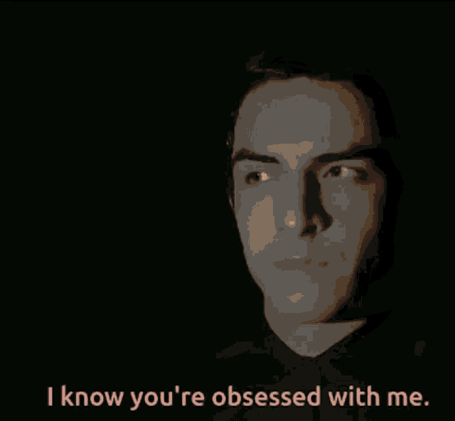a close up of a man 's face with the words " i know you 're obsessed with me " below it