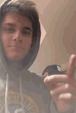 a man wearing a hoodie that says ' 3tm tht ' on it