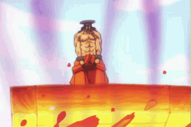 a man without a shirt is standing on top of a red and yellow item