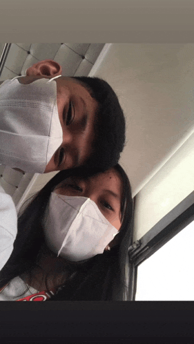 a man and a woman wearing face masks with the word coca cola on the shirt