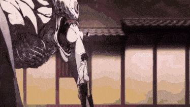 a man is standing in front of a monster with a large mouth