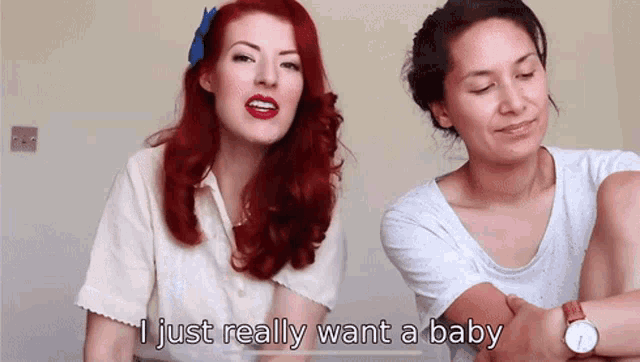 a woman with red hair says i just really want a baby next to another woman