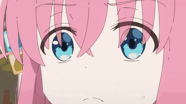 a close up of a girl 's face with blue eyes