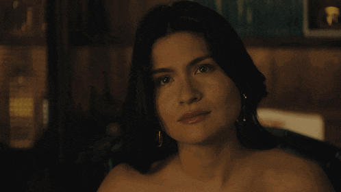 a naked woman with her eyes closed and earrings on