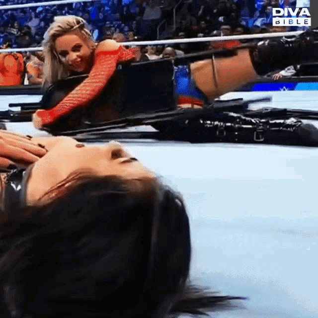 two women are wrestling in a diva bible wrestling match