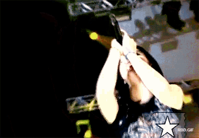 a woman singing into a microphone with a rbd.gif watermark on the bottom