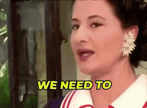 a woman with a flower in her ear is saying we need to .