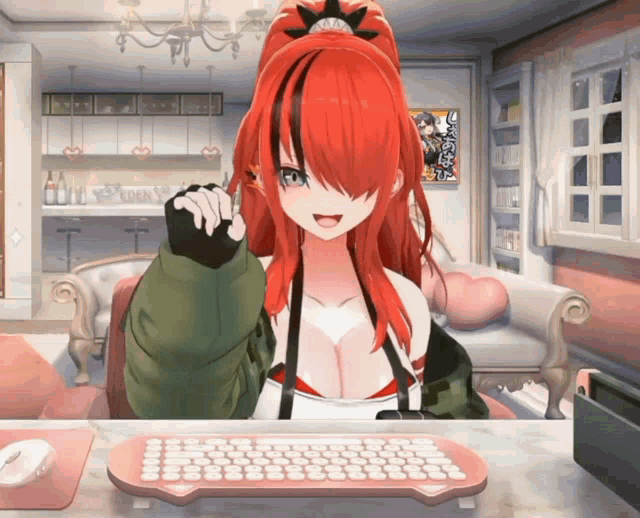 a girl with red hair is sitting at a desk with a keyboard and mouse
