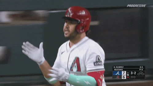a baseball player wearing a white jersey with the letter a on the front