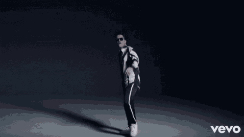 a man in a striped shirt and tie is surrounded by diamonds and the word vevo on the bottom