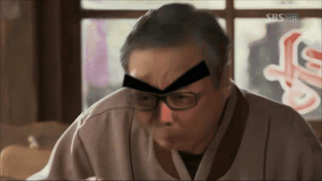 a man wearing glasses has a sticker on his forehead that says sbs hd