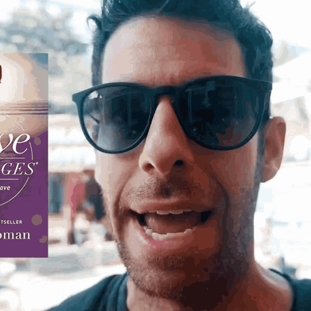 a man wearing sunglasses stands in front of a sign that says ' love ges '