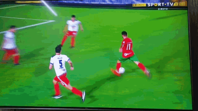 a soccer game is being played on a tv screen and the player in red has the number 17 on his jersey