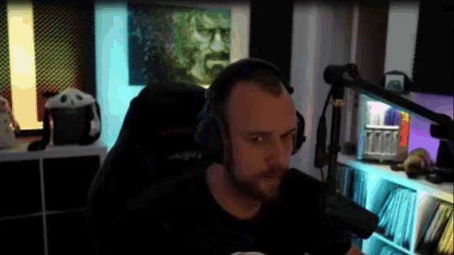 a man is sitting in front of a microphone wearing headphones .