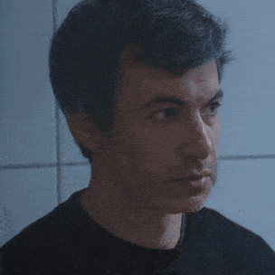 a close up of a man 's face with his eyes closed
