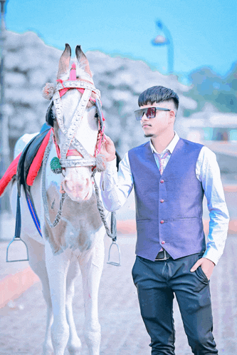 a man standing next to a horse with a bridle on it