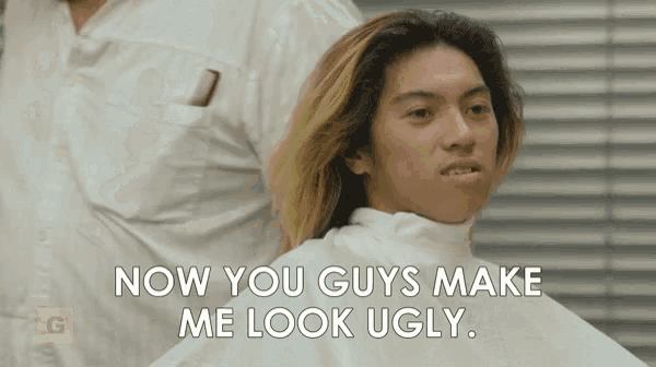 a man is getting his hair cut at a barber shop and says `` now you guys make me look ugly '' .