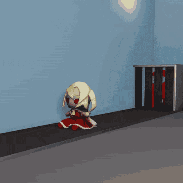 a little girl in a red dress is sitting under a metal object