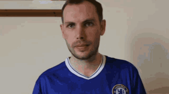 a man is wearing a blue chelsea shirt