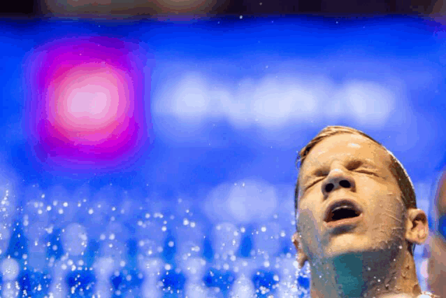 a man in a pool with his eyes closed