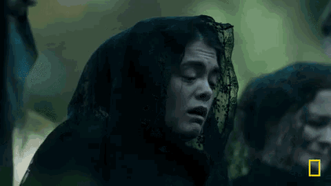 a woman with a black veil on her head is crying in a scene from a movie