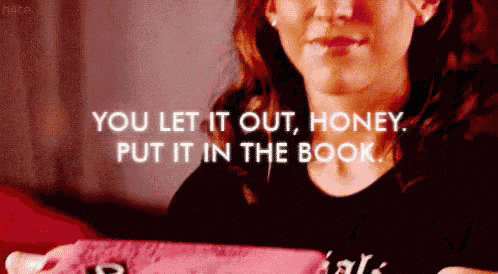 a woman is holding a pink box with the words " you let it out honey put it in the book " written on it