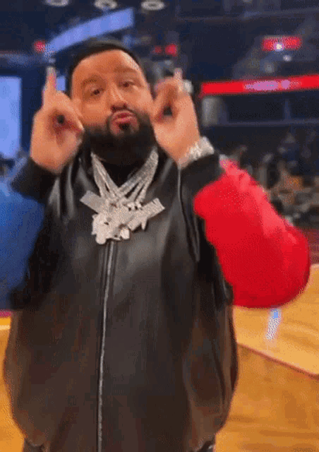 a man with a beard is wearing a black leather jacket and a red jacket