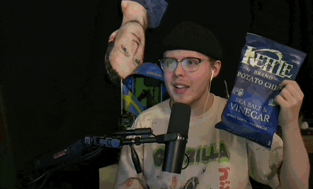 a man wearing headphones is talking into a microphone in front of a sunflower