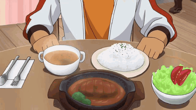 a person is sitting at a table with a plate of food and a bowl of soup with a tv channel visible in the background