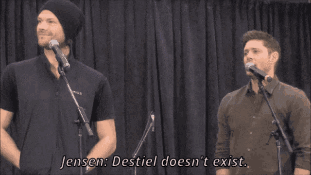 two men standing in front of microphones with the words jensen destiel does n't exist