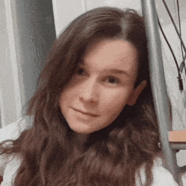 a close up of a woman 's face with long hair