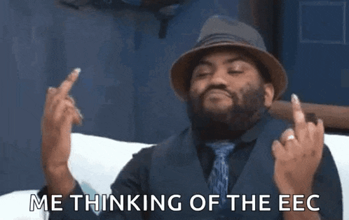 a man wearing a hat and tie is giving the middle finger and says " me thinking of the eec "