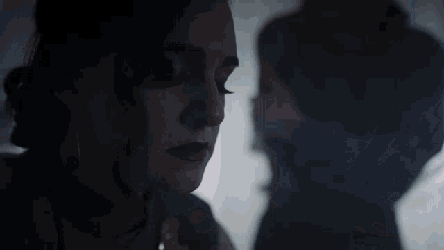 a woman holding a child in a dark room