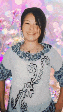 a woman wearing a blue and white shirt with a floral design