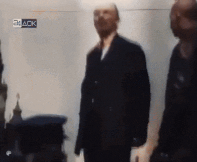 a blurry picture of a man in a suit with the letters 24 aok on the bottom