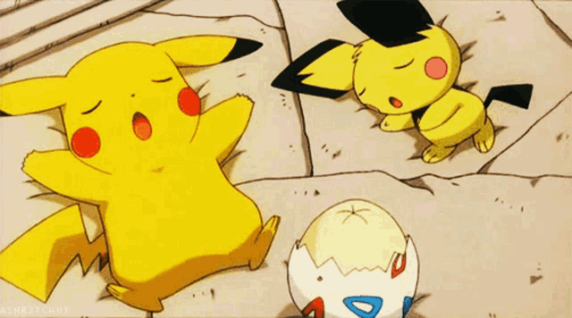 a pikachu laying on the ground next to an egg