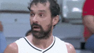 a man with a beard is wearing a white shirt