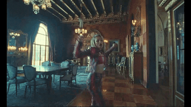 a woman in a red outfit is dancing in a dining room