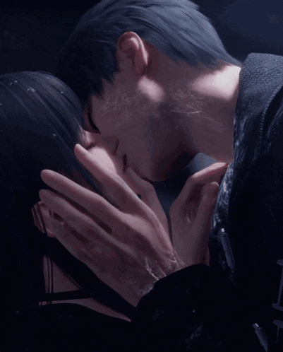 a man and woman are kissing in the dark
