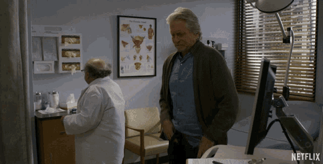 two men standing in a room with a netflix logo on the bottom right