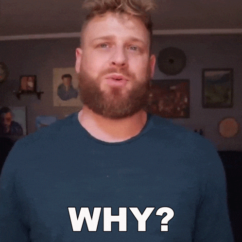 a man with a beard and a blue shirt is asking why