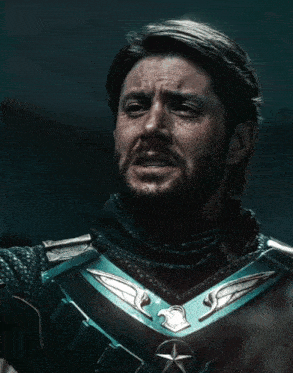 a man with a beard is wearing a blue armor with an eagle and star on it