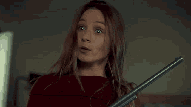 a woman holding a gun with the words the situation is balls behind her