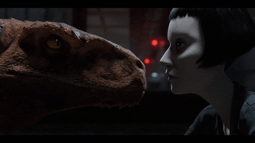 a woman and a dinosaur look at each other in a dark room