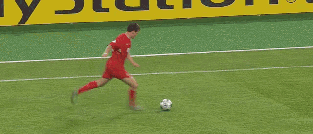 a soccer player in a red shirt is running on a field .